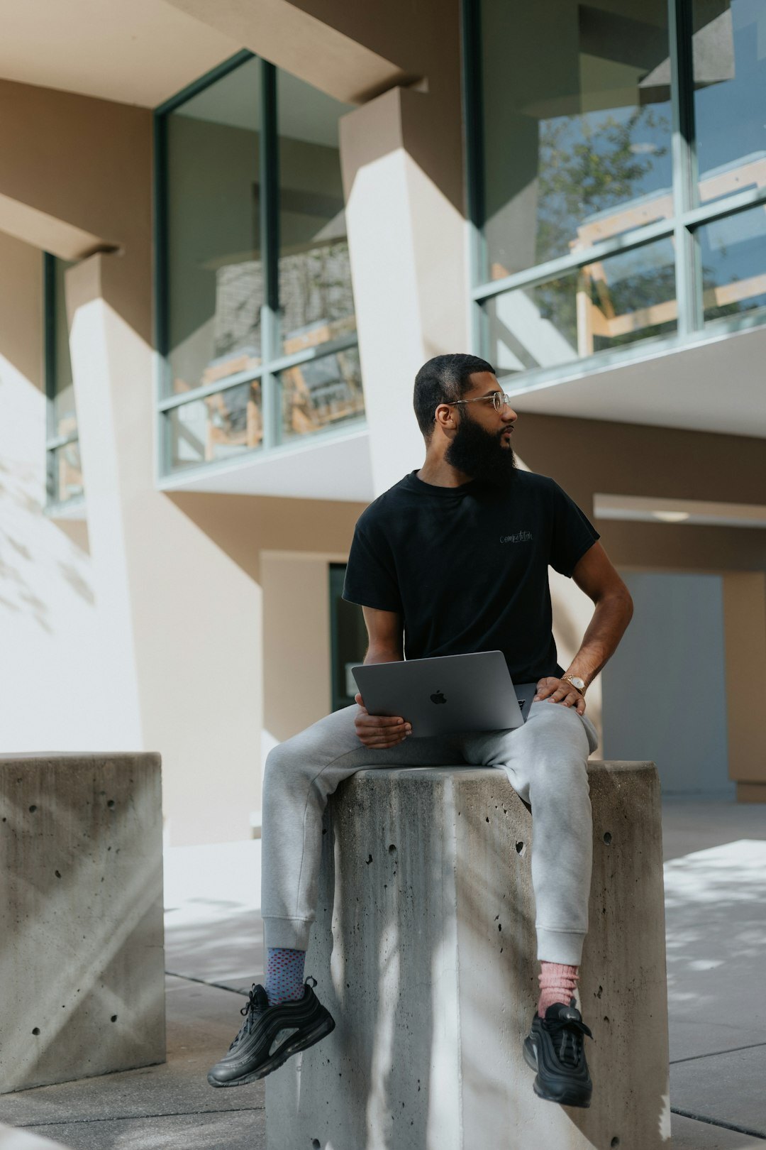 Professional analyzing charts and data on a laptop screen in a modern office