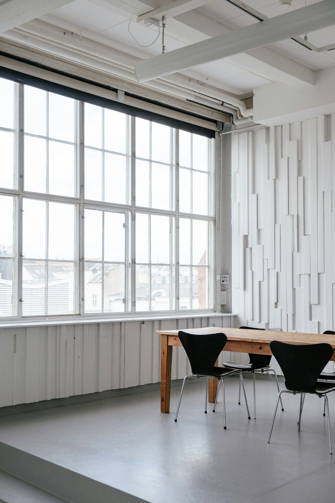 Group of diverse professionals discussing ideas around a table in a bright office