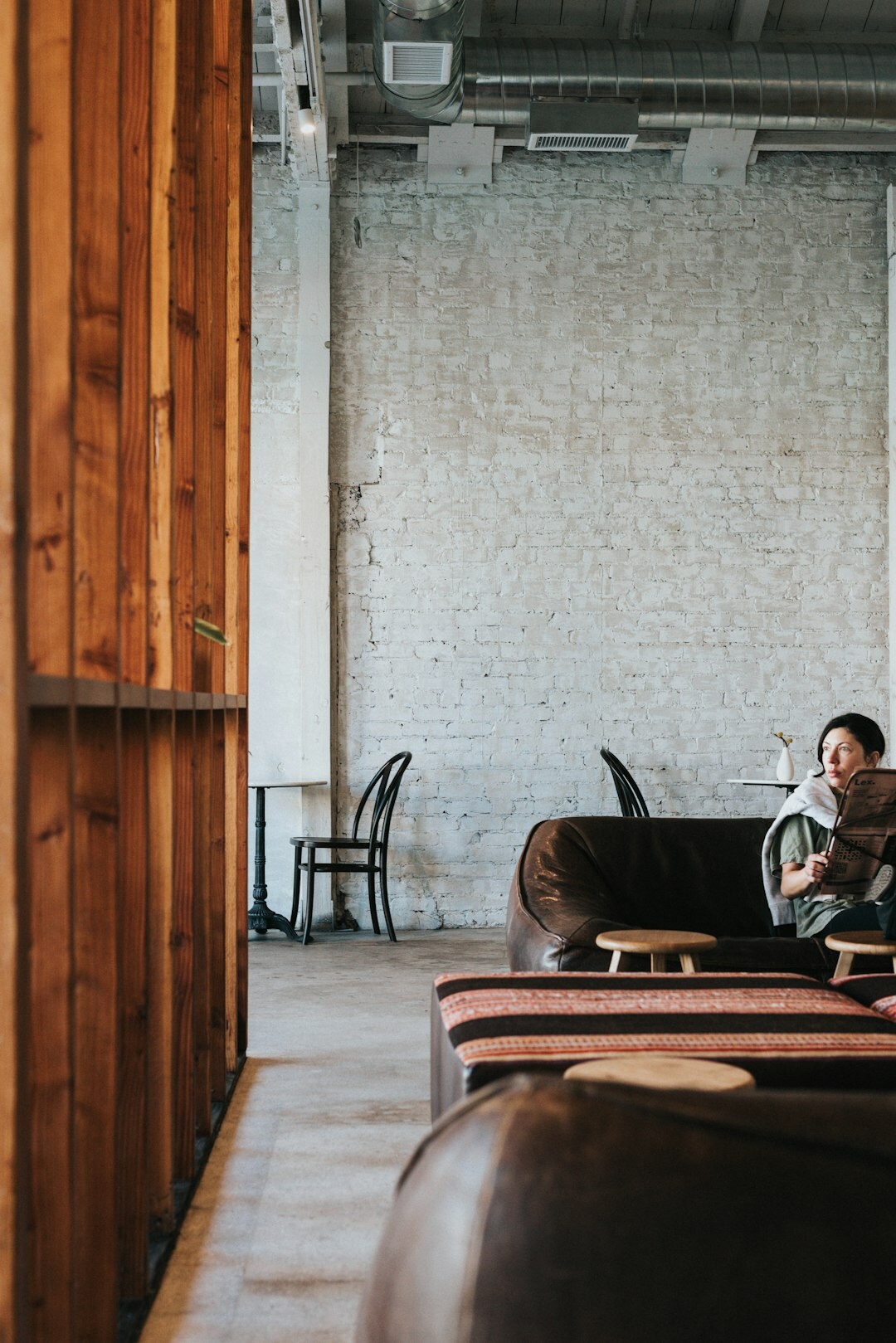 Two professionals having a friendly conversation over coffee in a modern lounge